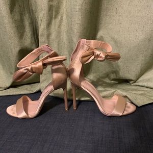 Gold stiletto heal with bow around ankle